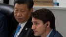 Canadian Prime Minister Justin Trudeau and Chinese President Xi Jinping listen to opening remarks at a plenary session at the G20 Summit in Osaka, Japan, Friday June 28, 2019. THE CANADIAN PRESS/Adrian Wyld