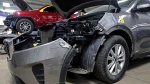 FILE - A Kia which was damaged after being stolen is seen at an auto repair shop in M