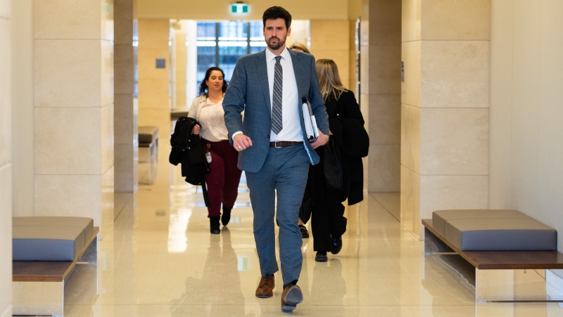 Minister of Immigration, Refugees and Citizenship, Sean Fraser, makes his way to the Standing Committee on Citizenship and Immigration to discuss the Government's Response to the Final Report of the Special Committee on Afghanistan in Ottawa, on Wednesday, Feb. 8, 2023. THE CANADIAN PRESS/Spencer Colby