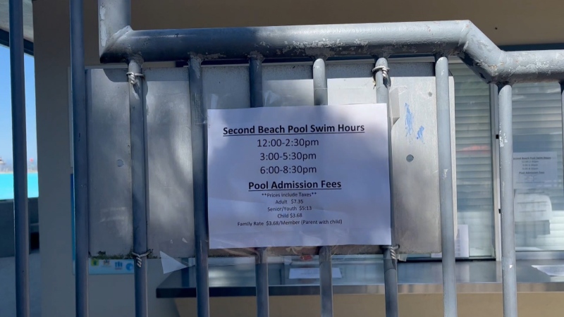 A sign showing the hours for Second Beach Pool is seen. (CTV)
