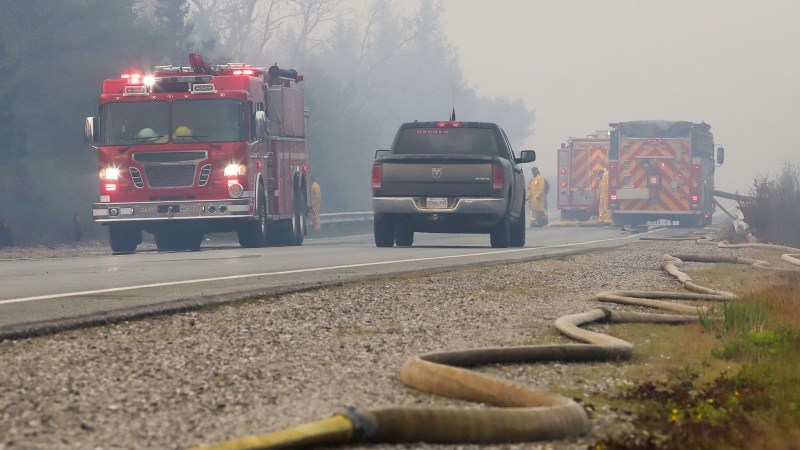A fire hose lies along highway 103 while fire crews work on wildfire flareups near Shelburne, Nova Scotia, N.S. in this Saturday, June 3, 2023 handout photo. (THE CANADIAN PRESS/HO-Communications Nova Scotia)
