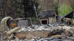 Remnants of a home damaged by a wildfire are seen in Hammonds Plains, N.S., during a media tour, Tuesday, June 6, 2023. THE CANADIAN PRESS/POOL, Tim Krochak