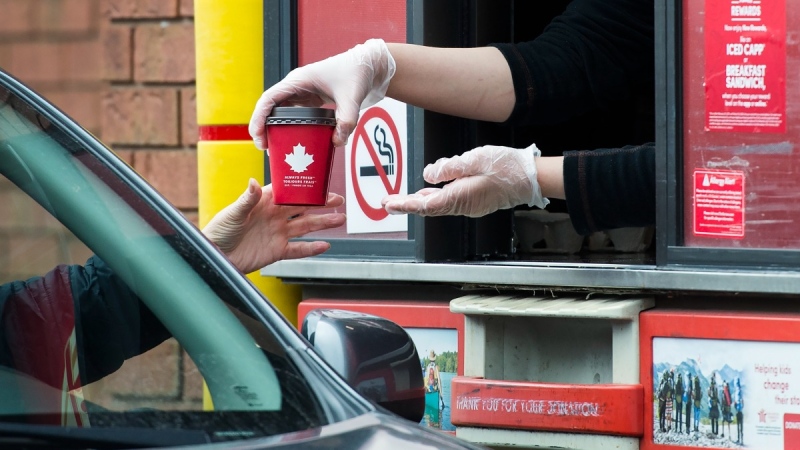 At a Tim Hortons drive-through window in Mississauga, Ont., on March 17, 2020. (Nathan Denette / THE CANADIAN PRESS)