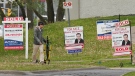 A person walks past multiple for-sale and sold real estate signs in Mississauga, Ont., on Wednesday, May 24, 2023. THE CANADIAN PRESS/Nathan Denette