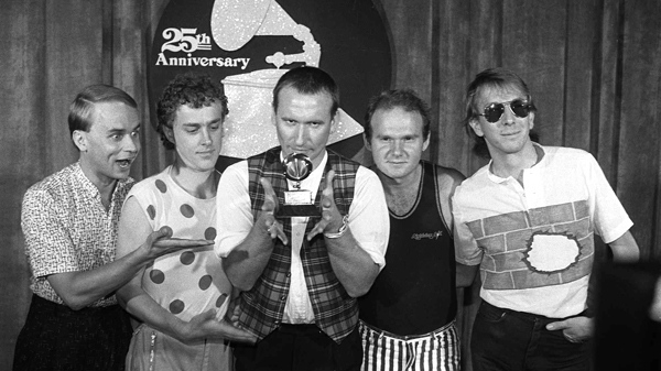 Members of 'Men at Work' pose with their Grammy for best new artist at the awards show in Los Angeles in this Feb. 22, 1983 photo. From left: Greg Hamm, Ron Strykert, Colin Hay, Jerry Speiser and John Rees. (AP Photo)