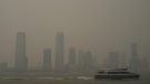 Buildings in Jersey City, N.J. are partially obscured by smoke from Canadian wildfires as a ferry travels up the Hudson River, seen from the Manhattan borough of New York on Tuesday, June 6, 2023. (Patrick Sison/AP)