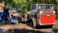 An encampment for those experiencing houselessness was dismantled by a skid steer on the 1800 block of Halifax Street. (Wayne Mantyka/CTV News)