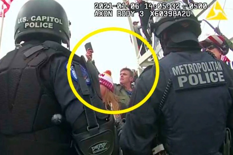 This image from Washington Metropolitan Police Department body-worn video, released and annotated by the Justice Department in the statement of facts supporting an arrest warrant for Jay James Johnston, shows Johnston, circled in yellow, at the U.S. Capitol on Jan. 6, 2021, in Washington. Johnston, the actor known for his roles on the comedy television shows "Bob's Burgers" and "Mr. Show with Bob and David," has been arrested on charges that he joined a mob of Donald Trump supporters in confronting police officers during the U.S. Capitol riot. (Justice Department via AP)