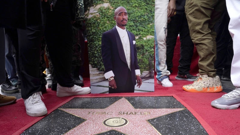 An image of the late rapper/actor Tupac Shakur appears near his new star on the Hollywood Walk of Fame during a posthumous ceremony in his honor on Wednesday, June 7, 2023, in Los Angeles. (AP Photo/Chris Pizzello)
