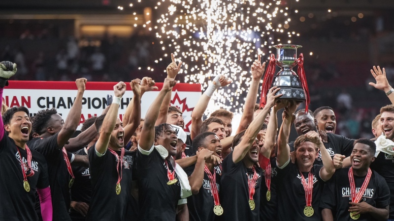 Vancouver Whitecaps' Russell Teibert, front third right, and Ryan Gauld, front second right, hoist the Voyageurs Cup after Vancouver defeated CF Montreal 2-1 during the Canadian Championship soccer final, in Vancouver, on Wednesday, June 7, 2023. THE CANADIAN PRESS/Darryl Dyck