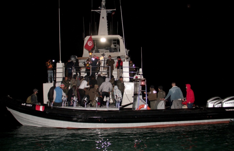 Migrants, mainly from sub-Saharan Africa, are stopped by Tunisian Maritime National Guard at sea during an attempt to get to Italy, near the coast of Sfax, Tunisia, Tuesday, April 18, 2023. The Associated Press, on a recent overnight expedition with the National Guard, witnessed migrants pleading to continue their journeys to Italy in unseaworthy vessels, some taking on water. (AP Photo)