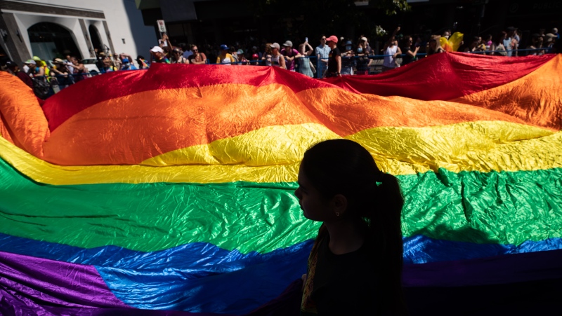 In this file photo, a giant rainbow flag is carried during the Vancouver Pride Parade, in Vancouver, on Sunday, July 31, 2022. THE CANADIAN PRESS/Darryl Dyck