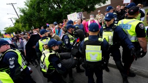A counter protester is arrested while confronting a protest against Pride in Ottawa, Friday, June 9, 2023. (Sean Kilpatrick/THE CANADIAN PRESS)