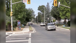 A car hits a bicycle median at the intersection of Queens Avenue and English Street in London, Ont. on June 9, 2023. (Sean Irvine/CTV News London)