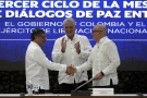 Cuban President Miguel Diaz-Canel applauds as Colombia's President Gustavo Petro, left, and ELN commander Antonio Garcia shake hands during a bilateral ceasefire agreement signing ceremony between Petro's government and the Colombian National Liberation Army (ELN) guerrilla, at El Laguito in Havana, Cuba, Friday, June 9, 2023. (AP Photo/Ramon Espinosa)