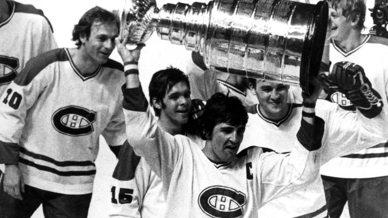 Montreal Canadiens' captain Serge Savard leads his teammates around the ice in a victory parade here, holding the Stanley Cup which they had just won for the fourth consecutive time. L to R are, Guy Lafleur, Rejean Houle, Savard, Rick Chartraw and Pierre Mondou. This victory was the Canadiens' 22nd victory. (CP PHOTO) 1979