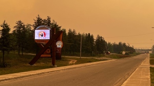 Smoke is seen obscuring the sky on the Ouje-Bougoumou Cree Nation, Que., in a June 6, 2023, handout photo. Three First Nations community in northern Quebec was abruptly evacuated Tuesday as an out-of-control wildfire lurched closer to the community. THE CANADIAN PRESS/HO-Deputy Chief Lance Cooper