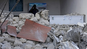 A soldier stands guard near the destroyed wall of the Pearl Beach hotel in Mogadishu, Somalia , Saturday, June 10, 2023. (AP Photo/ Farah Abdi Warsameh)