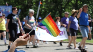A rainbow flag flies as marchers of the 2023 Queen City Pride Parade enter Wascana Park. (David Prisciak/CTV News)