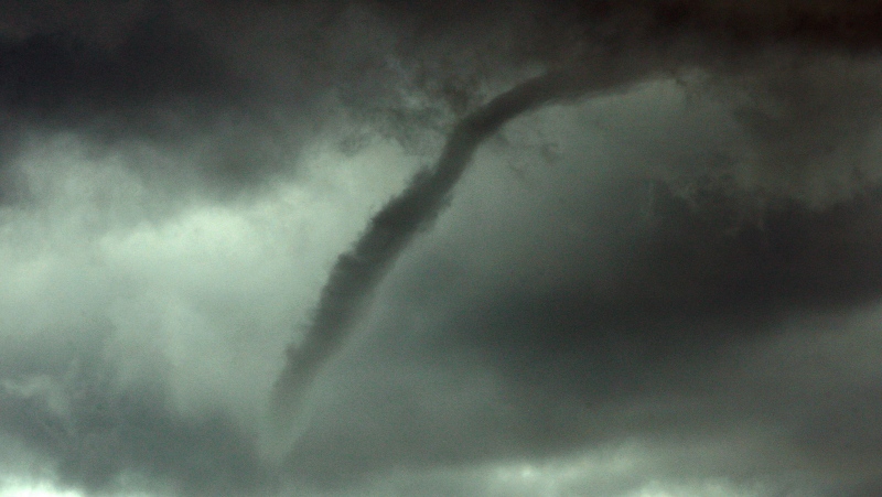 A funnel cloud appears in the sky southwest of Mills, Wyo., as a storm passes through the area Wednesday afternoon, July 16, 2014. (AP Photo/Casper Star-Tribune, Alan Rogers)