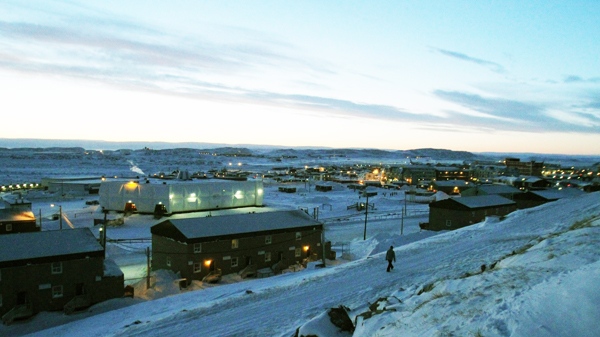 A lone person walks down a street as the sun sets in the northern community of Iqaluit, Nunavut, Thursday, Feb. 4, 2010. Iqaluit is the site of the G7 Finance Minister's meeting. (Fred Chartrand / THE CANADIAN PRESS)