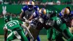 Winnipeg Blue Bombers running back Brady Oliveira (20) runs the football against the Saskatchewan Roughriders during the second half of CFL football action in Regina, on Friday, June 16, 2023. THE CANADIAN PRESS/Heywood Yu