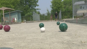Josh and Julia from Pure Country Sudbury play bocce ball at Robinson Playground in the South End area of Greater Sudbury.