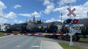 A DOT111 train car, centre, transports hazardous materials, also called "dangerous goods", in downtown Lac-Megantic, Que., Friday, May 26, 2023. THE CANADIAN PRESS/Stephane Blais