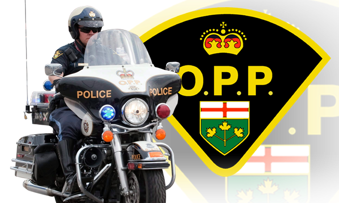OPP officer on a motorcycle with crest in background. (File photo/COURTESY OF OPP)