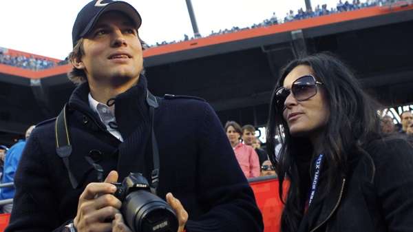 Ashton Kutcher and Demi Moore are seen on the sidelines before the NFL Super Bowl XLIV football game between the Indianapolis Colts and New Orleans Saints in Miami, Sunday, Feb. 7, 2010. (AP / Mike Groll)