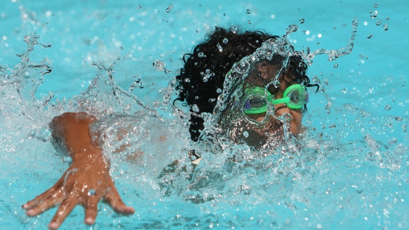 A lifeguard working at a public pool in Sherbrooke was assaulted by youths using the facility. A child cools off in the swimming pool on Monday June 28, 2010 in Fresno, Calif. (AP Photo/The Fresno Bee, Darrell Wong)