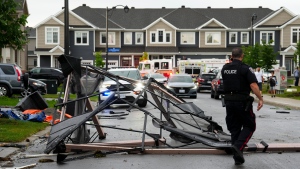 Debris fills the street following a tornado in the Ottawa suburb of Barrhaven on Thursday, July 13, 2023. (Sean Kilpatrick/THE CANADIAN PRESS)