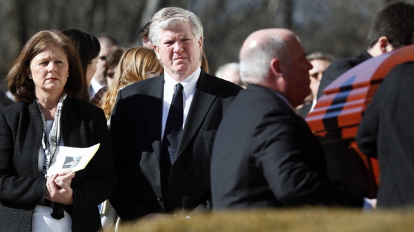 Brian Burke and his first wife Kerry, left, watch as the casket of their son Brendan is taken from the hearse into a memorial service in Canton, Mass., Tuesday, Feb. 9, 2010. (AP / Michael Dwyer)