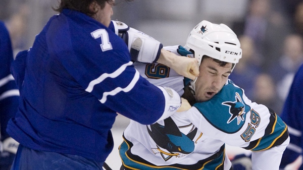 San Jose Sharks' Brad Staubitz, right, takes a hard punch to the head from Toronto Maple Leafs' Garnet Exelby during second period NHL hockey action in Toronto Monday, February 8, 2010. (Darren Calabrese/THE CANADIAN PRESS)