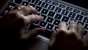 A woman uses her computer keyboard to type while surfing the internet in North Vancouver, B.C., Wednesday, Dec. 19, 2012. THE CANADIAN PRESS/Jonathan Hayward