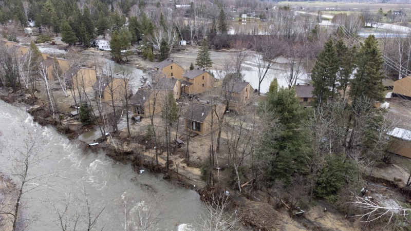 The Mares River flows by the Genevrier campground after a major spring flood forced the closing of roads and major highway, Tuesday, May 2, 2023 in Baie Saint-Paul Que. THE CANADIAN PRESS/Jacques Boissinot
