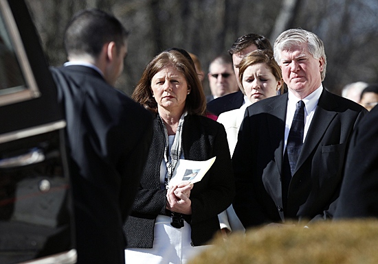 President and general manager of the Toronto Maple Leafs Brian Burke, right, and his first wife Kerry, left, watch as the casket of their son Brendan is taken from the hearse into a memorial service in Canton, Mass. on Tuesday, Feb. 9, 2010. (AP Photo/Michael Dwyer)