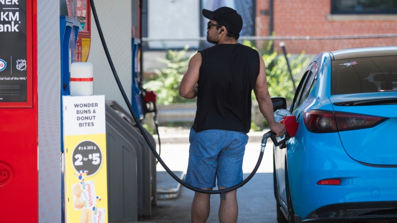 A commuter pumps gas into their vehicle at a Esso gas station in Toronto on Tuesday, June 15, 2021. THE CANADIAN PRESS/ Tijana Martin