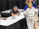 Kelly McCrimmon, the general manager of the Vegas Golden Knights, signs an autograph at the Keystone Centre in Brandon on July 21, 2023 (Image source Devon McKendrick/CTV News Winnipeg).