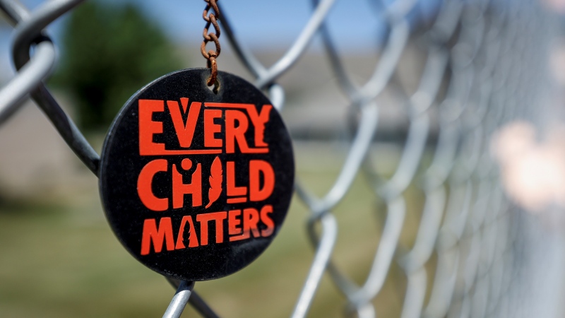 A key chain dangles from a fence as part of a memorial outside the former Kamloops Indian Residential School in Kamloops, B.C., Thursday, June 1, 2023. (THE CANADIAN PRESS/Jeff McIntosh)