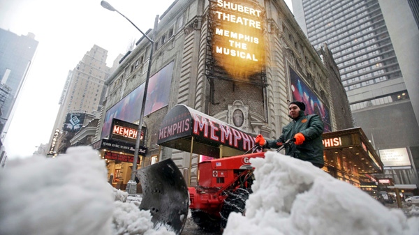John Sarria with S. L Green moves snow from Shubert Alley in New York's Broadway theatre district, Wednesday, Feb. 10, 2010. (AP / Richard Drew)