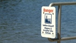 A warning sign to swimmers at Thetis Lake Regional Park. (CTV News)