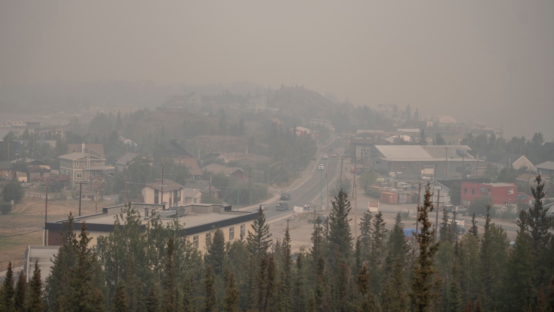 Heavy smoke from nearby wildfires fills the sky in Yellowknife on Tuesday, August 15, 2023. THE CANADIAN PRESS/Angela Gzowski