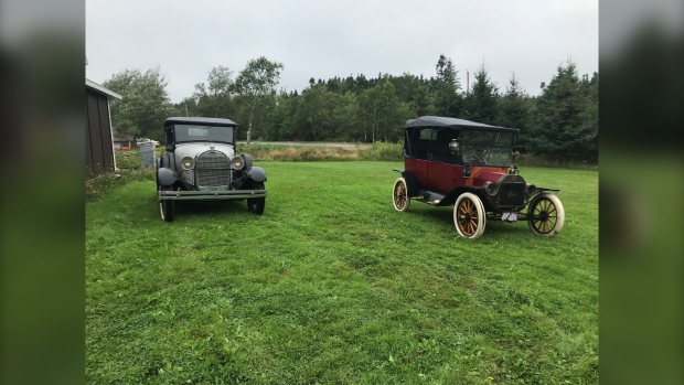 Dennis Harrietha of Mill Creek, N.S., is selling his 1914 Ford Model T car, which is the car in the right of this photo. (Ryan MacDonald/CTV Atlantic)