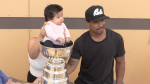 A child is placed in the Stanley Cup to pose with Vegas Golden Knight forward Keegan Kolesar on Aug. 22, 2023. (Source: Glenn Pismenny/CTV News Winnipeg) 