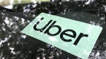 An Uber sign is displayed inside a car in Palatine, Ill., Monday, May 22, 2023. (AP Photo/Nam Y. Huh,File)