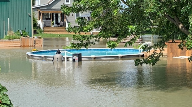 An above ground pool is surrounded by water after a storm caused flooding in Harrow, Ont., on Thursday, Aug. 24, 2023. (Bob Bellacicco/CTV News Windsor)