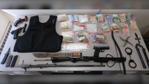 Police say officers seized over 135 grams of fentanyl, over 80 grams of cocaine, a handgun, a sawed-off shotgun, various weapons, a bullet-proof vest, numerous rounds of ammunition and more than $3,000 in cash from a home on Bulmer Avenue. (Supplied)