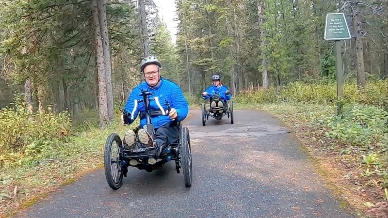 Ross Billings rides a three-wheel e-assisted bike on the accessible trails surrounding William Watson Lodge in Kananaskis, Alta.