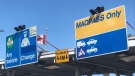 Toll booth signs for the Macdonald Bridge in Halifax are pictured on Sept. 1, 2023.
